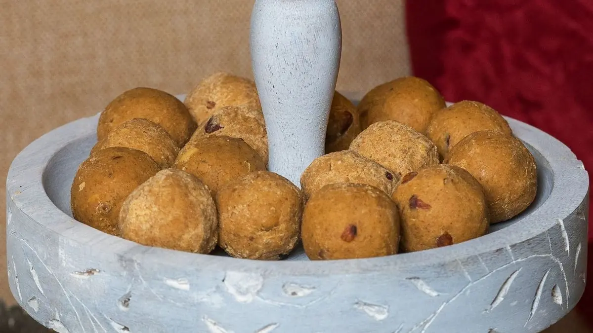 A tiered stand of besan laddoos on a dessert table