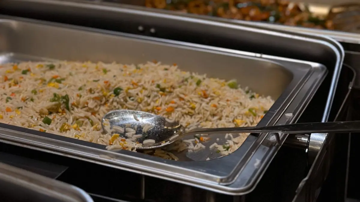 A tray of vegetable rice on a buffet counter at an Indian function