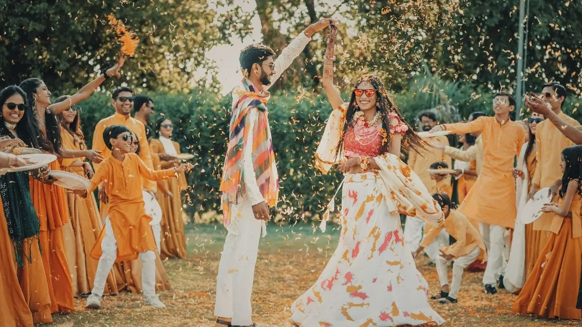 A haldi ceremony held outdoors on a lawn with marigold decor