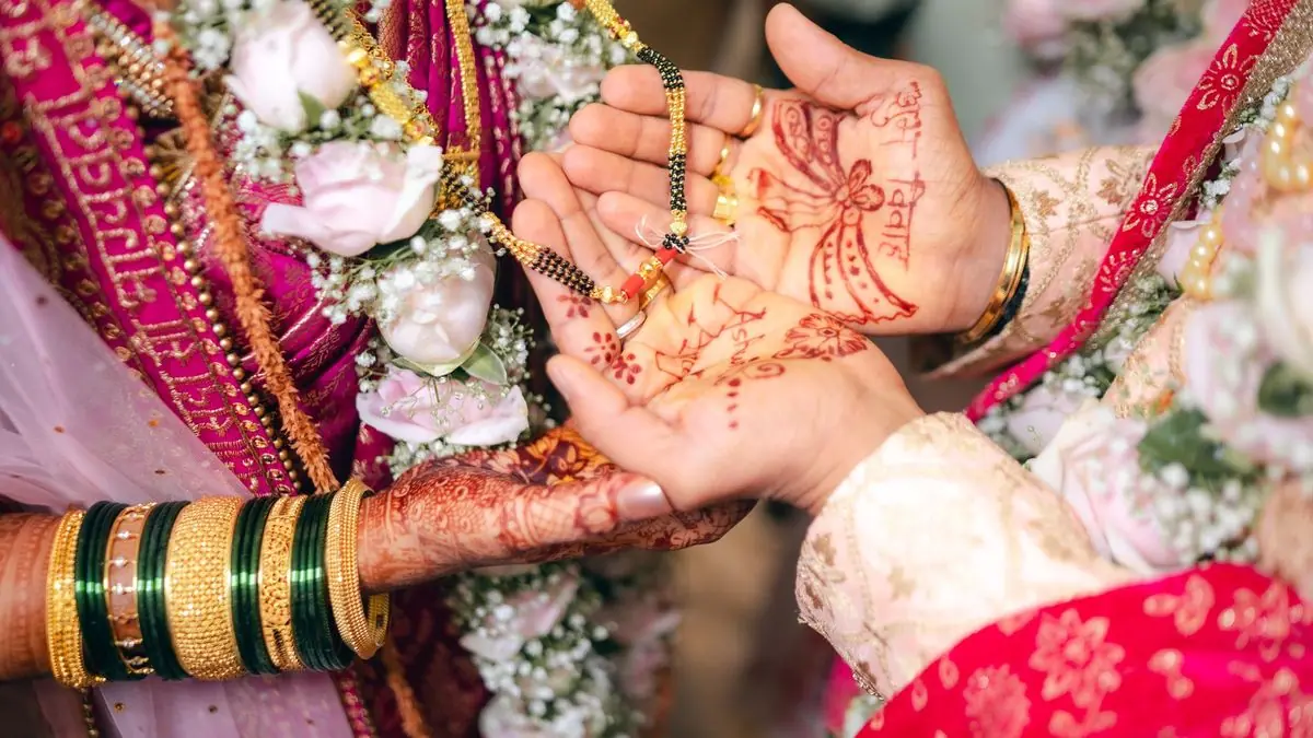 A bride's hands with fresh mehndi at a pre-wedding function