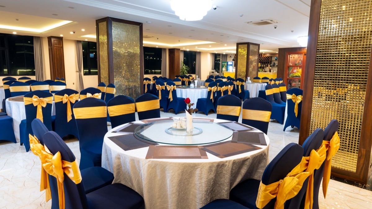 Banquet hall set with round tables and chair covers for a party