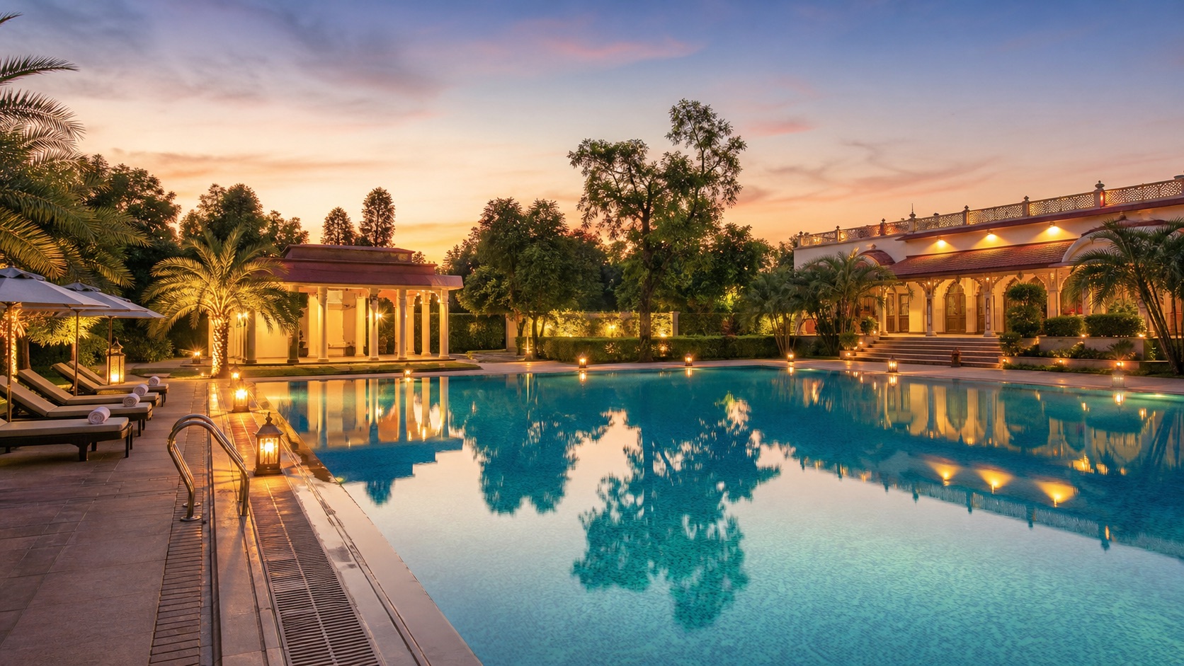 Resort swimming pool at dusk at The Heritage Resort, Misrod Bhopal